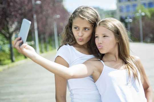 How Taking Selfies Can Take You Out Of The Moment