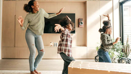 Woman and children dancing happily