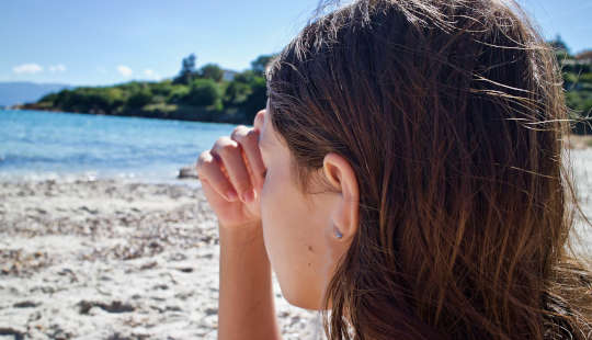 a woman looking out to sea