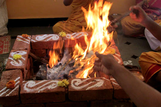 a picture of two arms reaching out into a square fire pit