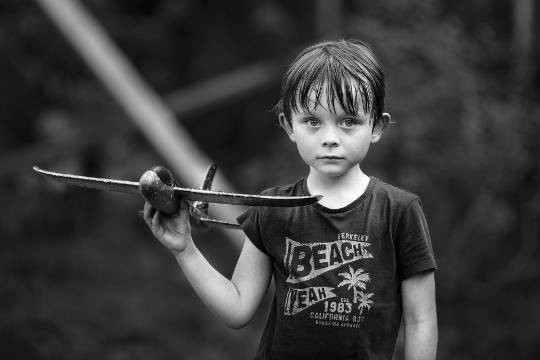 a child holding a balsa wood airplane