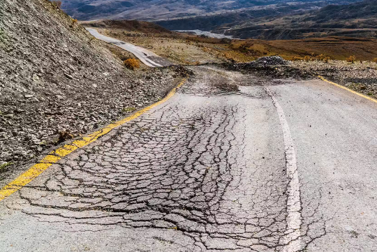 road with broken up sections and pavement