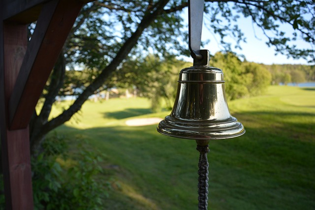 a bell or gong hanging from a tree