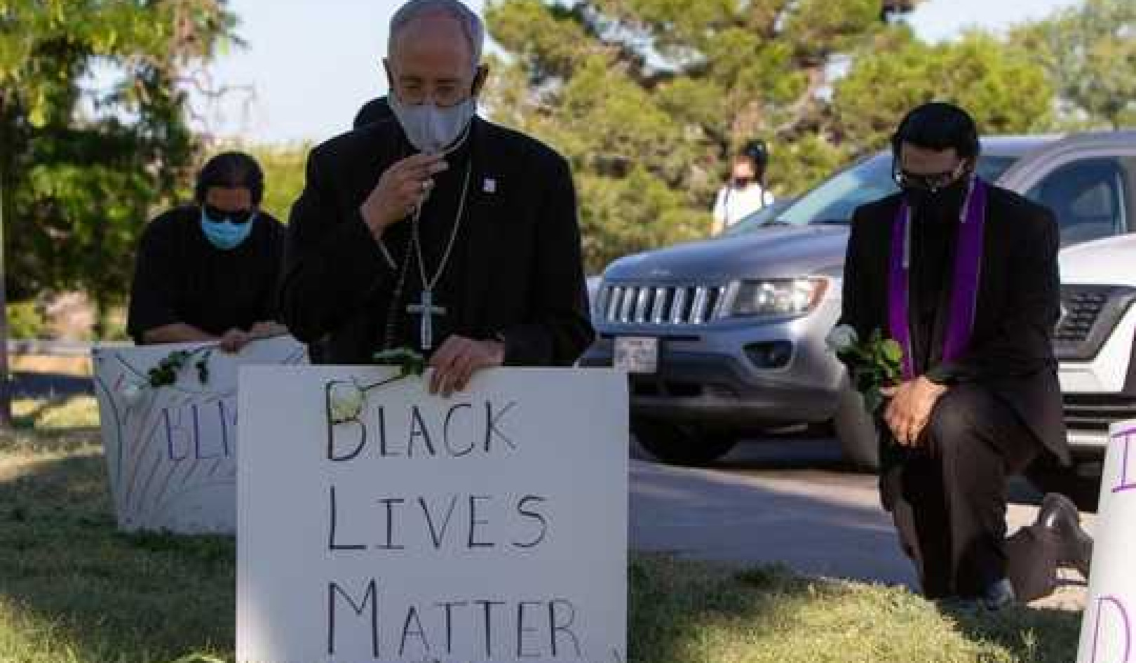 Why Catholic Priests Are Kneeling With Protesters