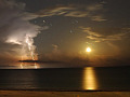 moon setting over the Gulf of Mexico illuminating clouds, sky, and water