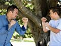 a father and son facing each other wearing boxing gloves