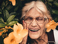 Elderly woman with bright smile symbolizing super aging and cognitive health