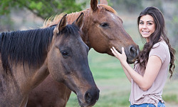 a young woman with two horses