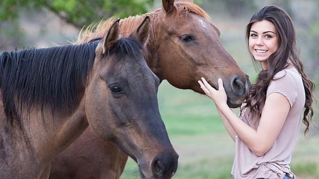 a young woman with two horses