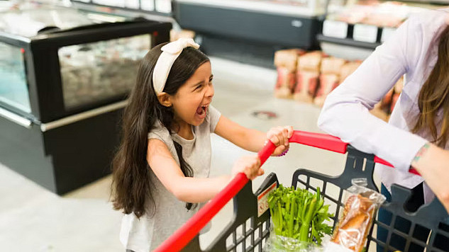 A child reacting strongly to sensory stimuli, highlighting challenges of sensory processing disorder, such as sensitivity to textures and sounds.