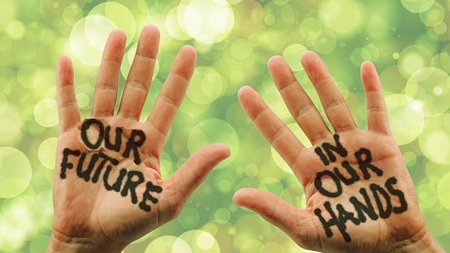 photo of two open hands with the words painted on them: Our Future in Our Hands