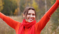 a woman smiling with arms raised up in expansive gesture