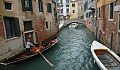 a gondola and other boats on a canal in Venice, Italy