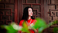 young woman in a red dress looking up at the sky