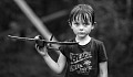 a child holding a balsa wood airplane