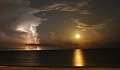 moon setting over the Gulf of Mexico illuminating clouds, sky, and water