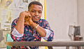 photo of a confident black man sitting at a table