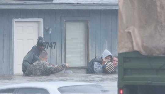 Army National Guardsmen help residents evacuate their homes in Fayetteville, North Carolina on Oct. 8. U.S. Army National Guard/Flickr, CC BY