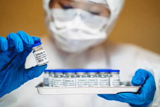 A researcher holding vials of COVID-19 vaccine that will be used in clinical trials. (how the civil war drove medical innovation and the pandemic could too)