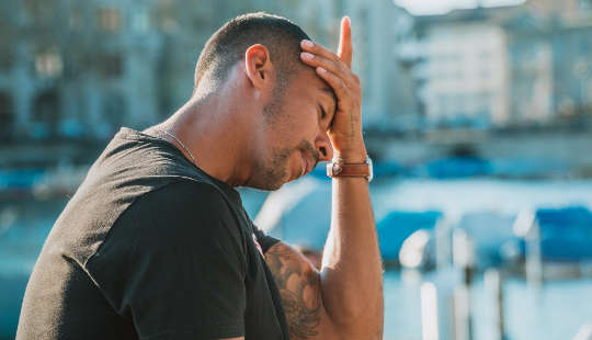 Pandemic Slog: 7 Steps to Extract Yourself and What To Do Instead a man sitting holding his head