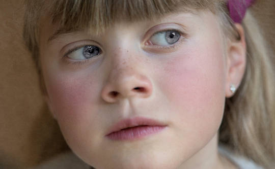 a young girl looking pensive