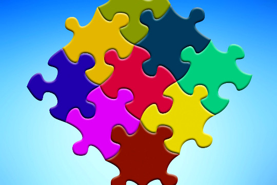 How to Heal Ourselves (and Each Other) from Separation Illness brightly multi-colored puzzle pieces joined together
