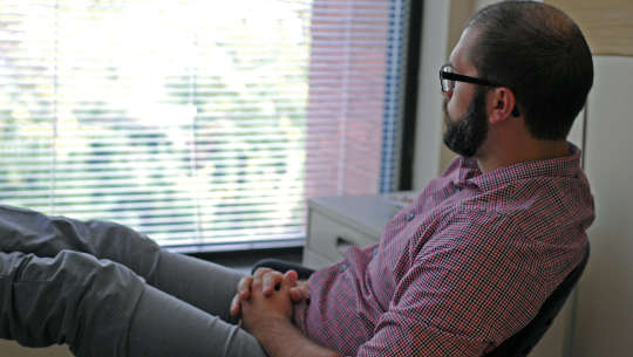 a man sitting and looking out the window