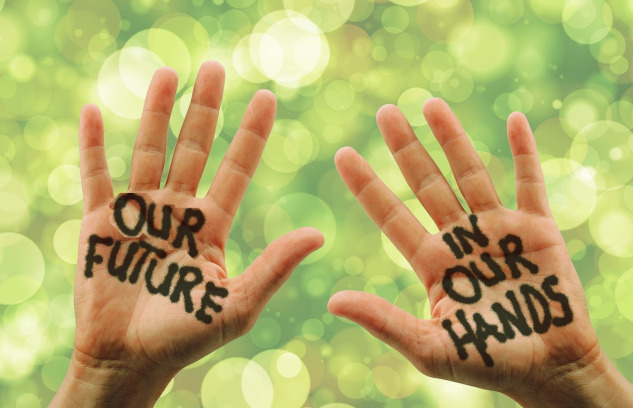 photo of two open hands with the words painted on them: Our Future in Our Hands