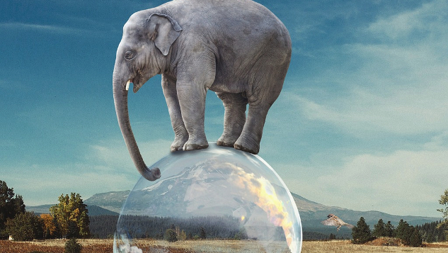 elephant balanced on the globe of planet earth