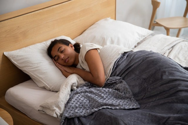 a woman laying in bed sleeping