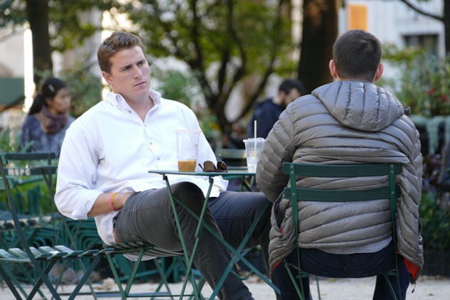 two men sitting facing each other