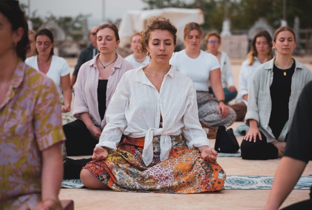 a group of women sitting together and meditating