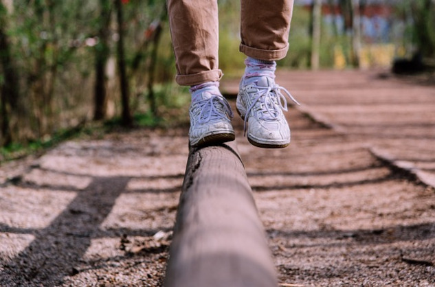 showing the feet and legs of someone balancing on one foot