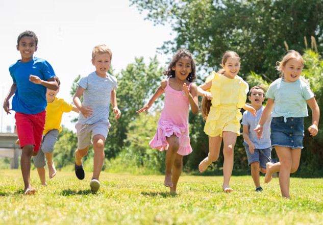 Preschoolers playing and engaging in physical activities outdoors, highlighting the importance of movement guidelines for child health and development.