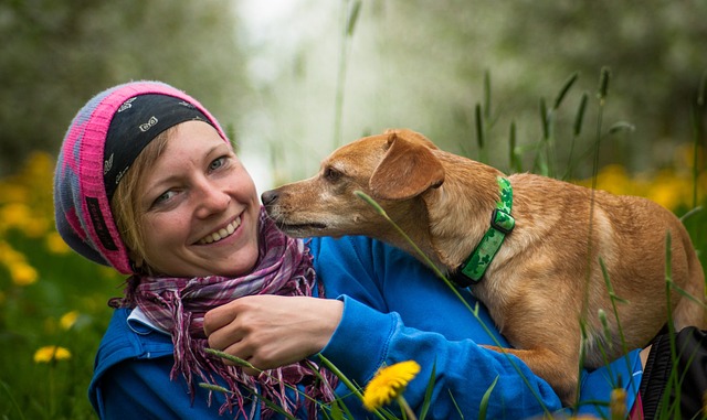 InnerSelf's Weekend Inspiration: March 28-29-30, 2025 A woman with a wide smile and her dog. Image by Susanne from Pixabay.