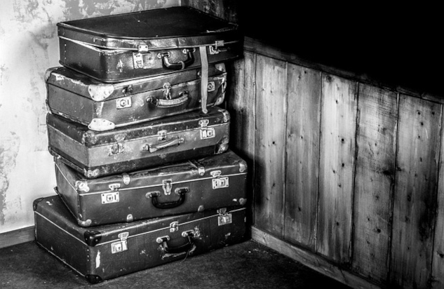 A stack of old suitcases. Image by Rudy and Peter Skitterians from Pixabay. 