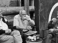 three older men sitting around talking