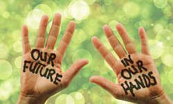 photo of two open hands with the words painted on them: Our Future in Our Hands