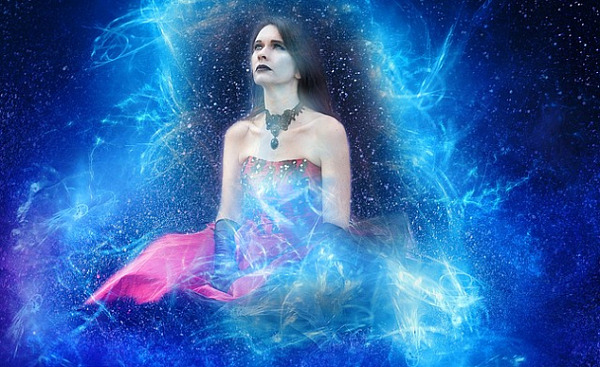 sitting woman surrounded by energy and the starry heavens