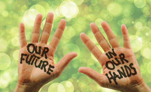 photo of two open hands with the words painted on them: Our Future in Our Hands