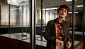 concerned-looking woman standing in an office setting