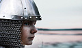 a female warrior with helmet and chain mail