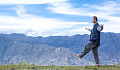 a man walking with arms wide open in a balanced pose