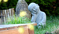 a small statue in a zen garden